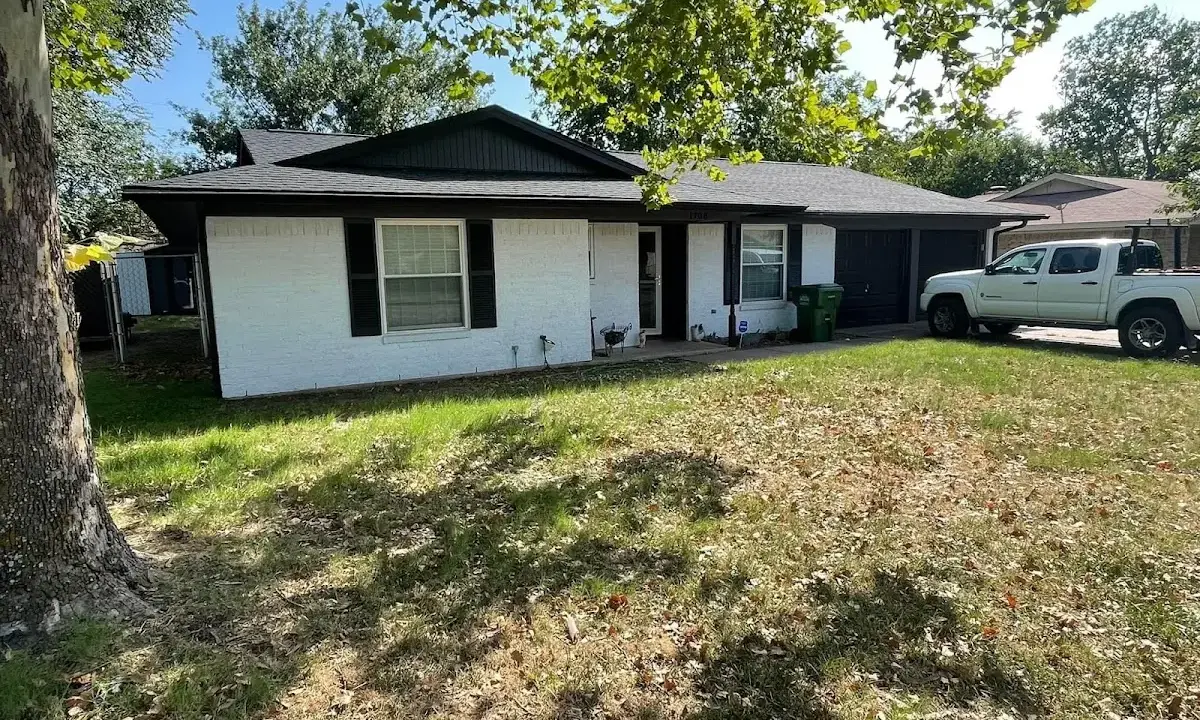 Professional roofing crew working on a residential roof in Ashland